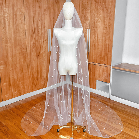 Cathedral length 3D silk petal veil displayed on a mannequin to show full dramatic drape.