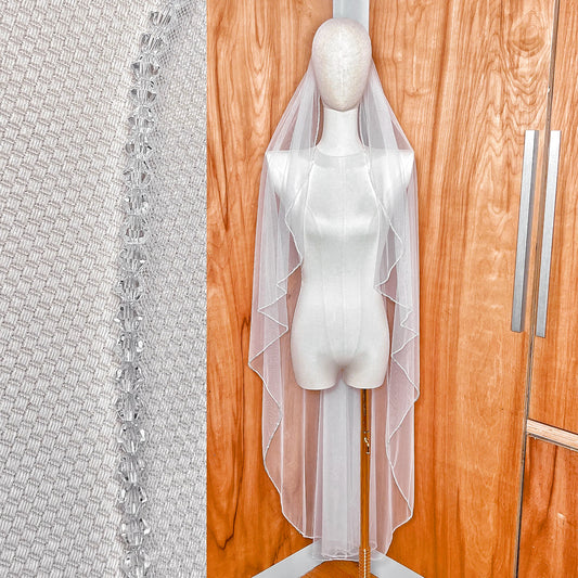 Front view of a waltz length Angel Cut crystal trim wedding veil featuring a shimmering beaded edge.