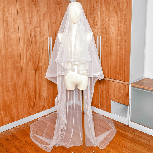 Full-length shot of a 1 1/2" horsehair trim wedding veil with blusher shown in cathedral length.