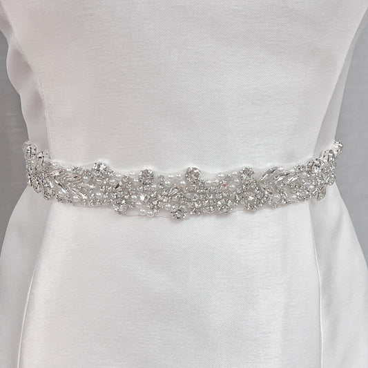 Elegant silver beaded bridal belt, 1.2 inches wide, showcasing intricate beadwork on a bridal mannequin.