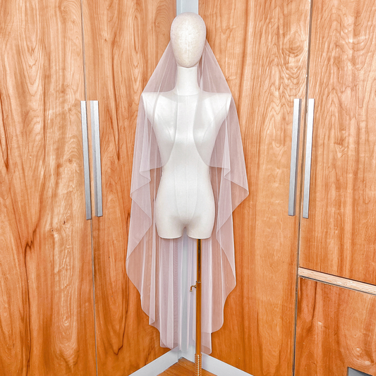 Front view of the cascade waltz length wedding veil with a clean raw edge finish.