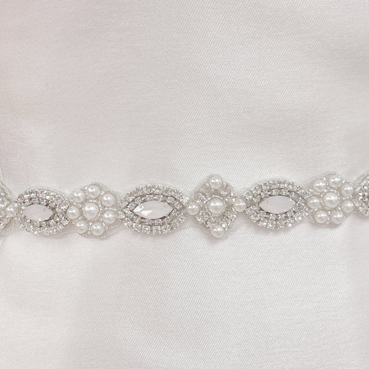 Close-up detail of the hand-stitched pearls and rhinestones on the Vintage Art Deco beaded wedding belt.