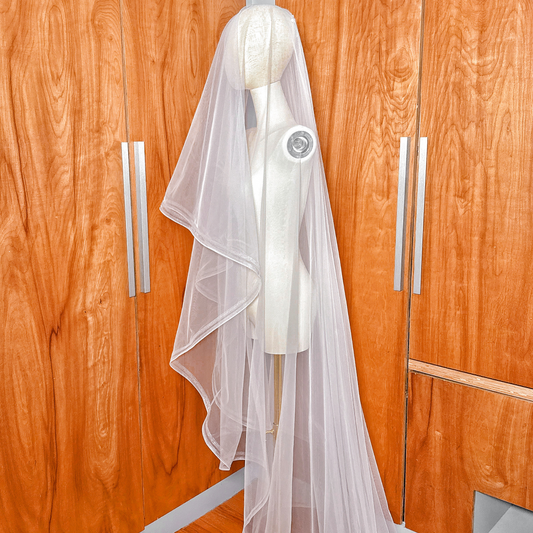 Elegant cathedral length double horsehair wedding veil shown on a mannequin studio setup.