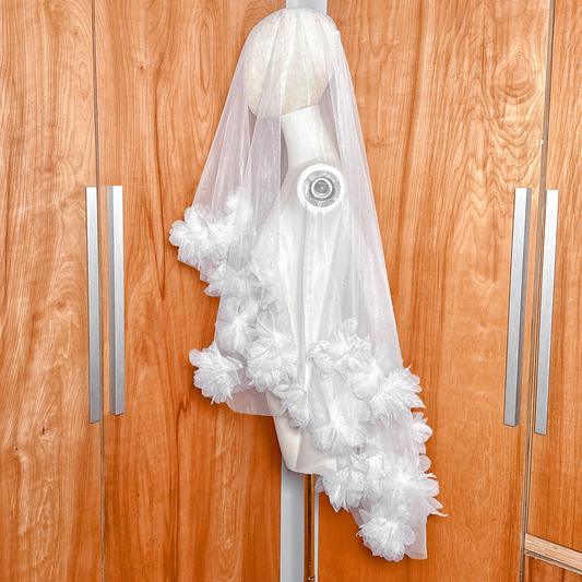 A two tier 3D flower wedding veil in fingertip length showcasing the soft floral border.