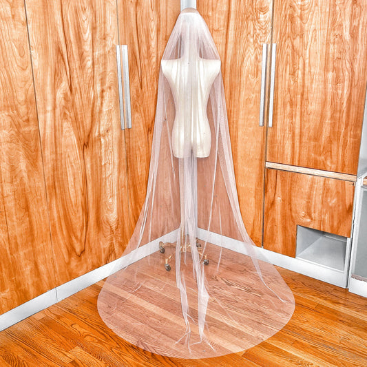 Back view of a cathedral length scattered rhinestone wedding veil flowing down beautifully.
