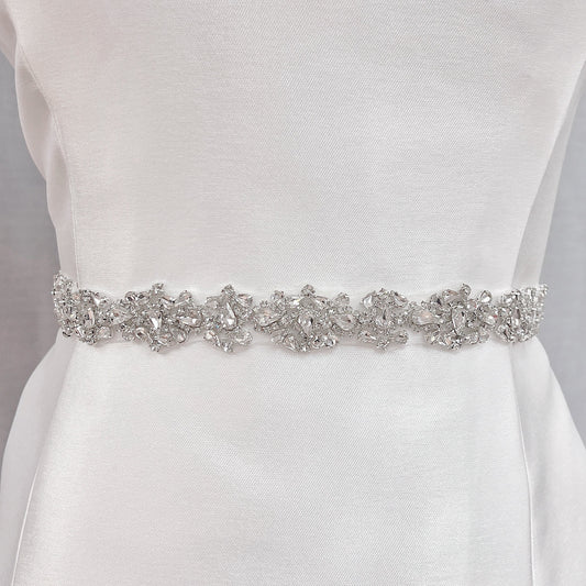 Silver beaded bridal belt featuring crystal rhinestones on a wedding dress sash, shown on a display mannequin.