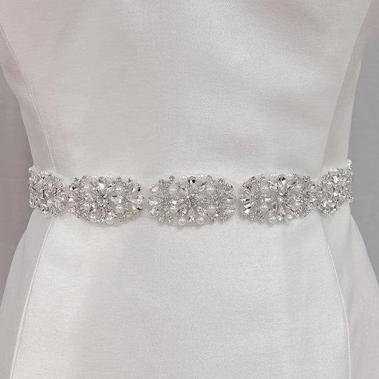 Full-length view of a silver rhinestone and pearl bridal belt.