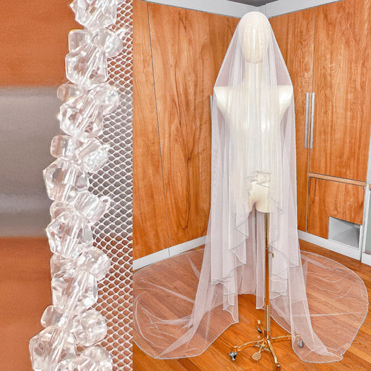 Front view showing the blusher tier forward on a two tier crystal beaded edge wedding veil.