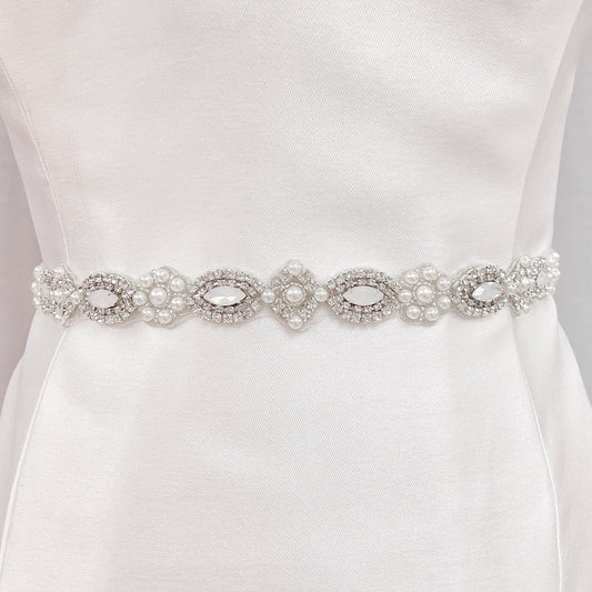 Art Deco beaded wedding belt with intricate silver geometric crystal patterns on a display bridal mannequin.