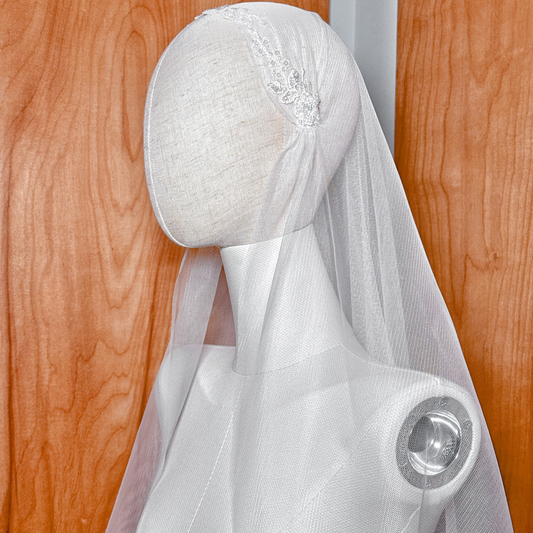 An angled profile of the beaded lace vintage style Juliet cap veil on a mannequin, perfect for showcasing 1920s bridal inspiration.