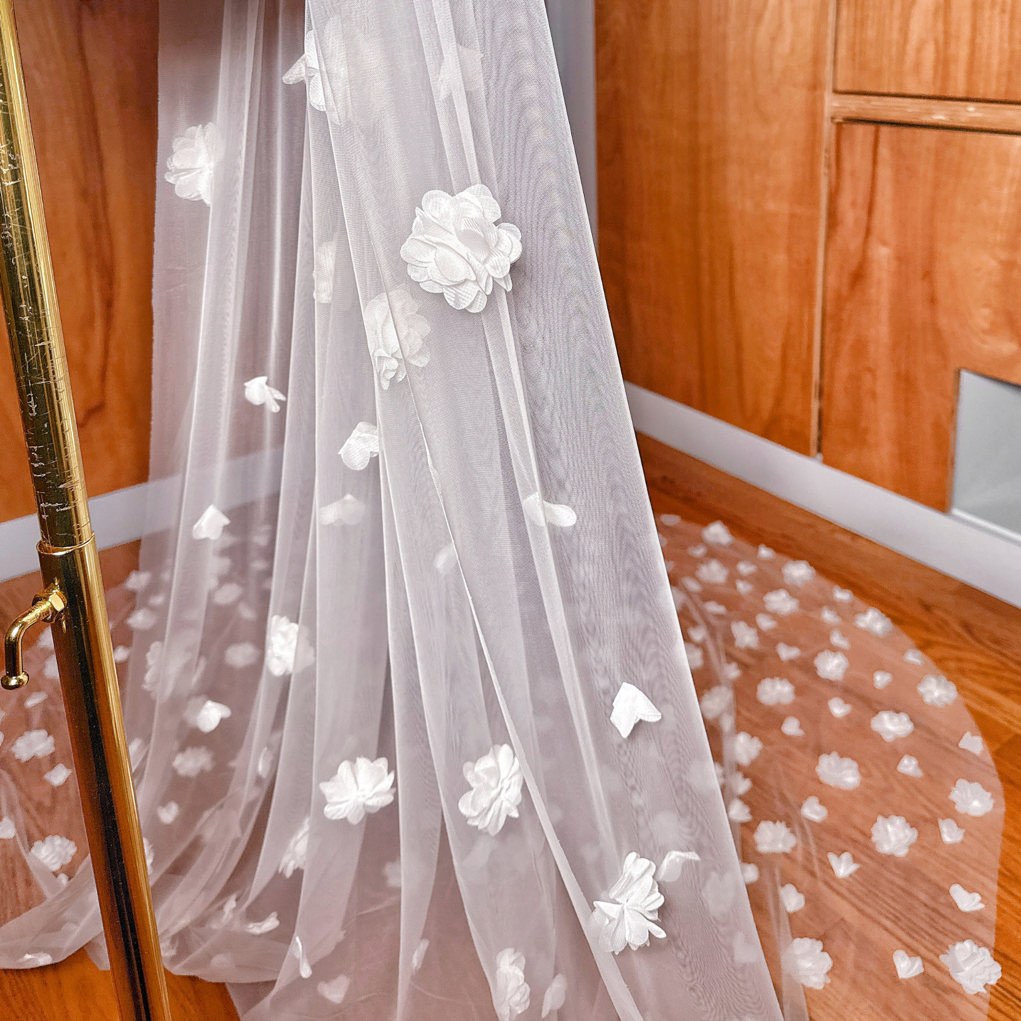 Close-up of dimensional petals on the allover 3D floral wedding veil cathedral length, highlighting the textured floral detail.