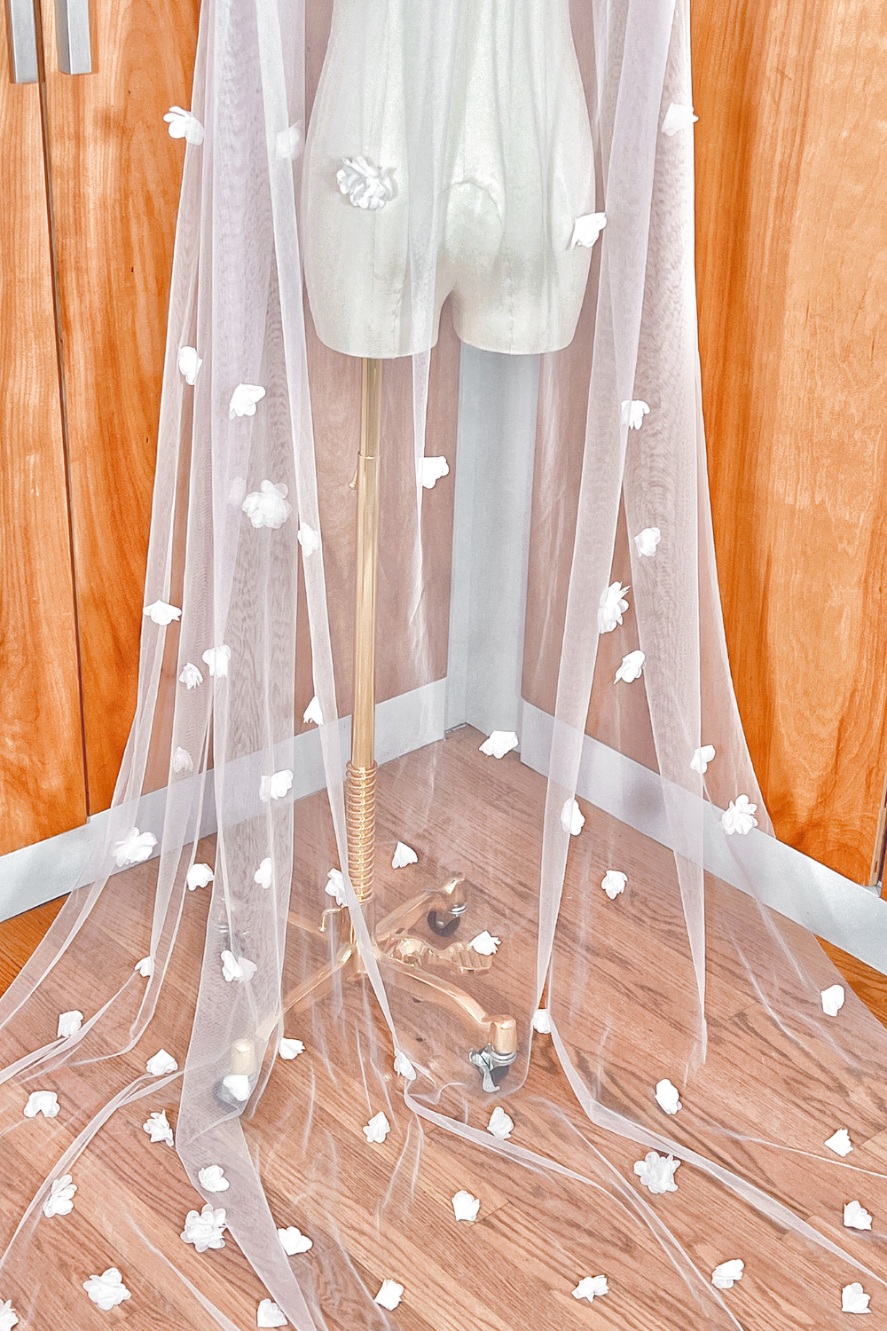 Close-up detail of intricate 3D floral lace embroidery on a cathedral length bridal veil.