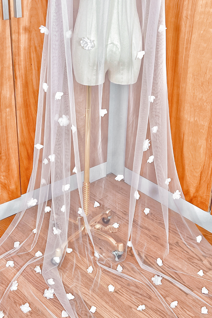 Close-up detail of intricate 3D floral lace embroidery on a cathedral length bridal veil.