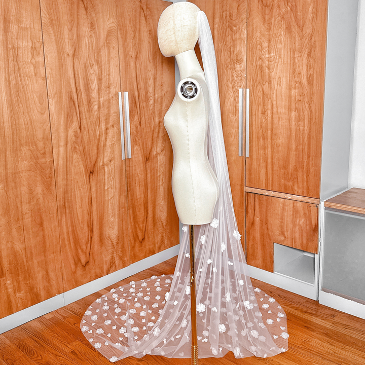 Cathedral length allover 3D floral wedding veil on a mannequin showing the front drape and intricate flower appliqués.