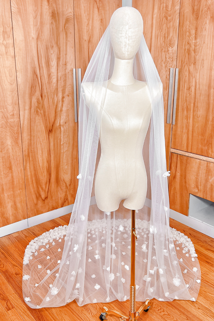 Front view of a cathedral length allover 3D floral wedding veil displayed on a bridal mannequin.