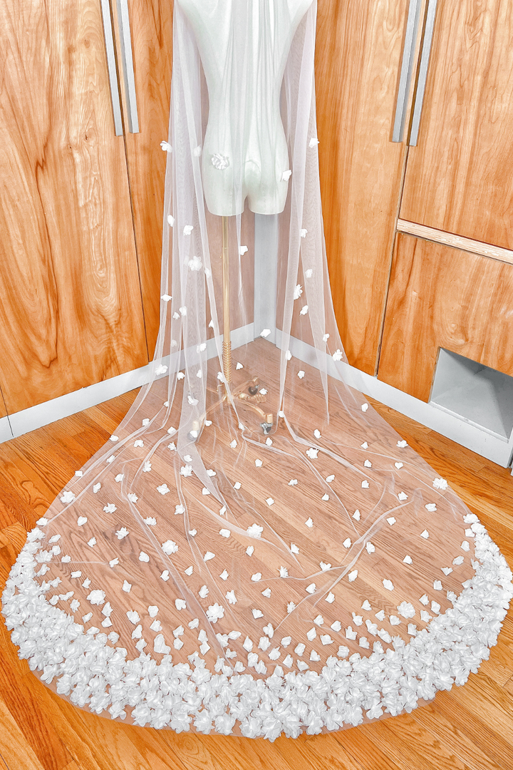 Soft tulle texture and 3D floral pattern on the long train of a cathedral length wedding veil.