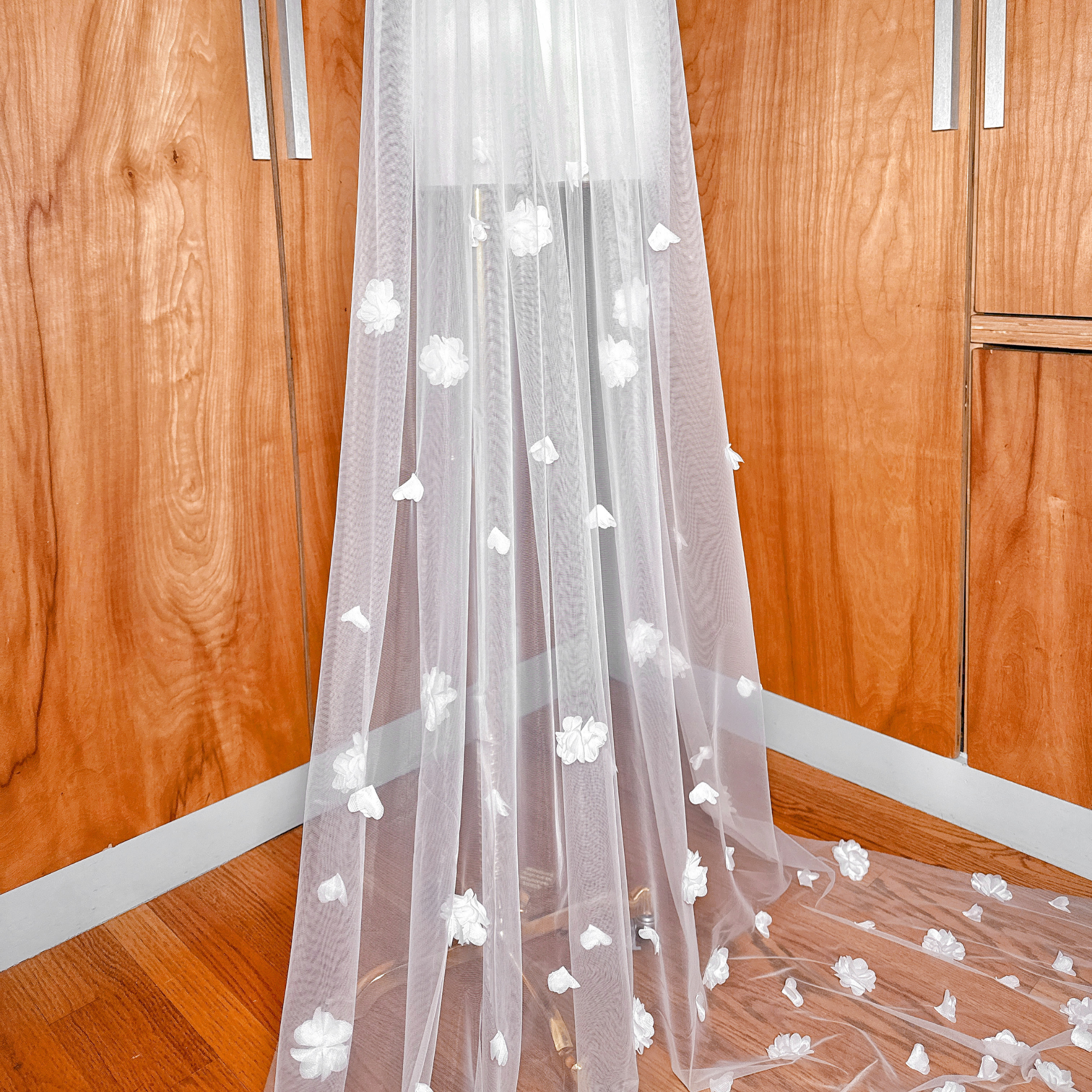 Detailed view of the allover 3D floral wedding veil in cathedral length, showcasing the concentrated floral border on a mannequin