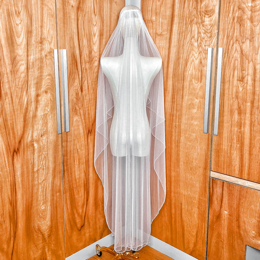 Back view of a sheer tulle Angel Cut crystal trim wedding veil in a 60-inch waltz length.