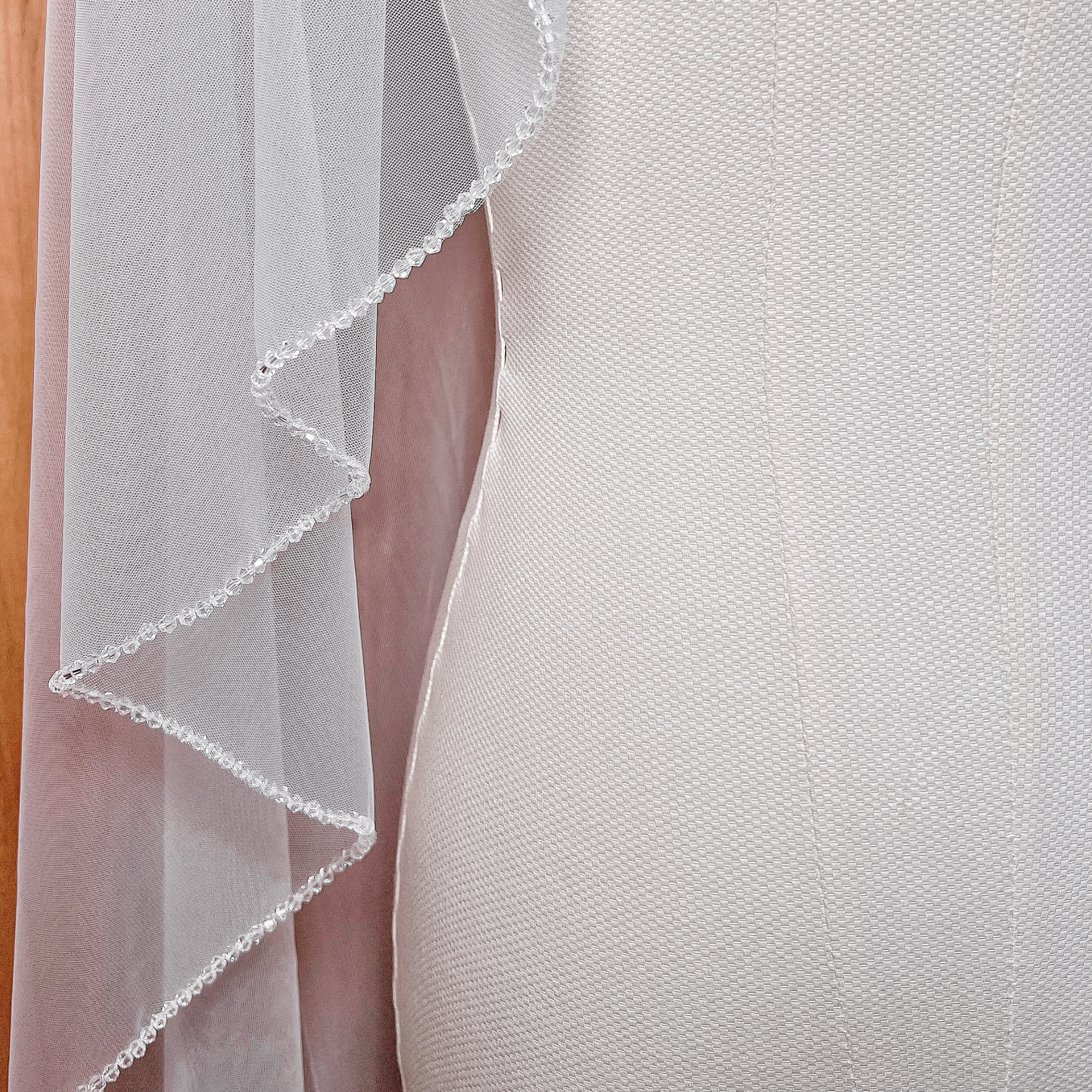 Side view profile displaying the elegant cascading drape of a waltz length Angel Cut wedding veil.