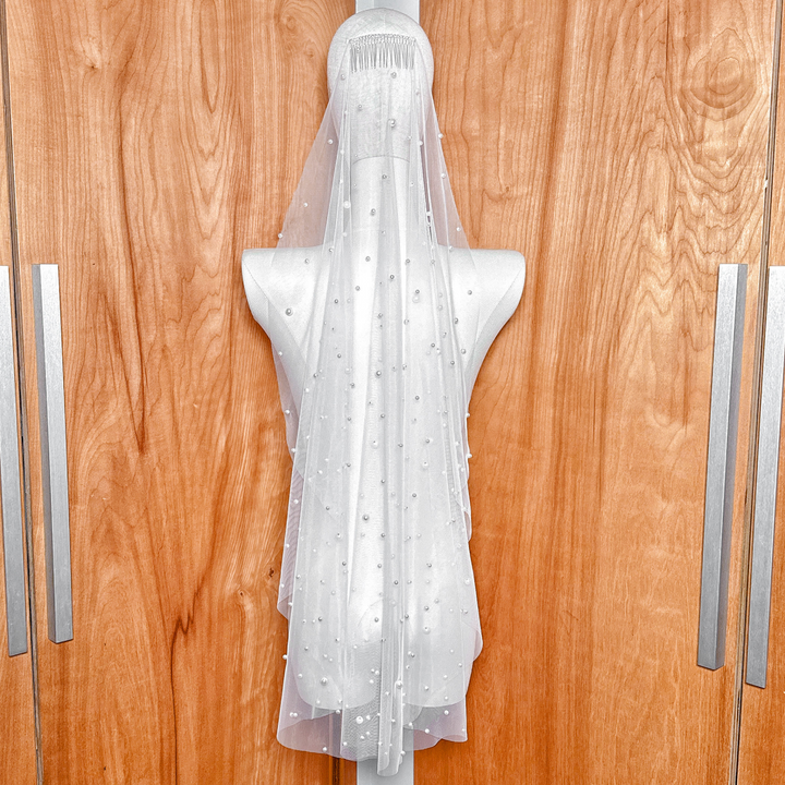 Back view of the Barely There Scattered Pearl Wedding Veil in fingertip length, displaying how the pearls catch the light across the shoulders.