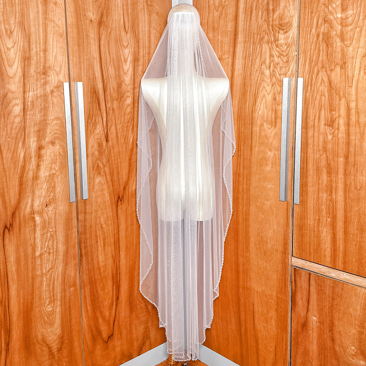 Back view of a waltz length crystal beaded edge wedding veil draping elegantly.
