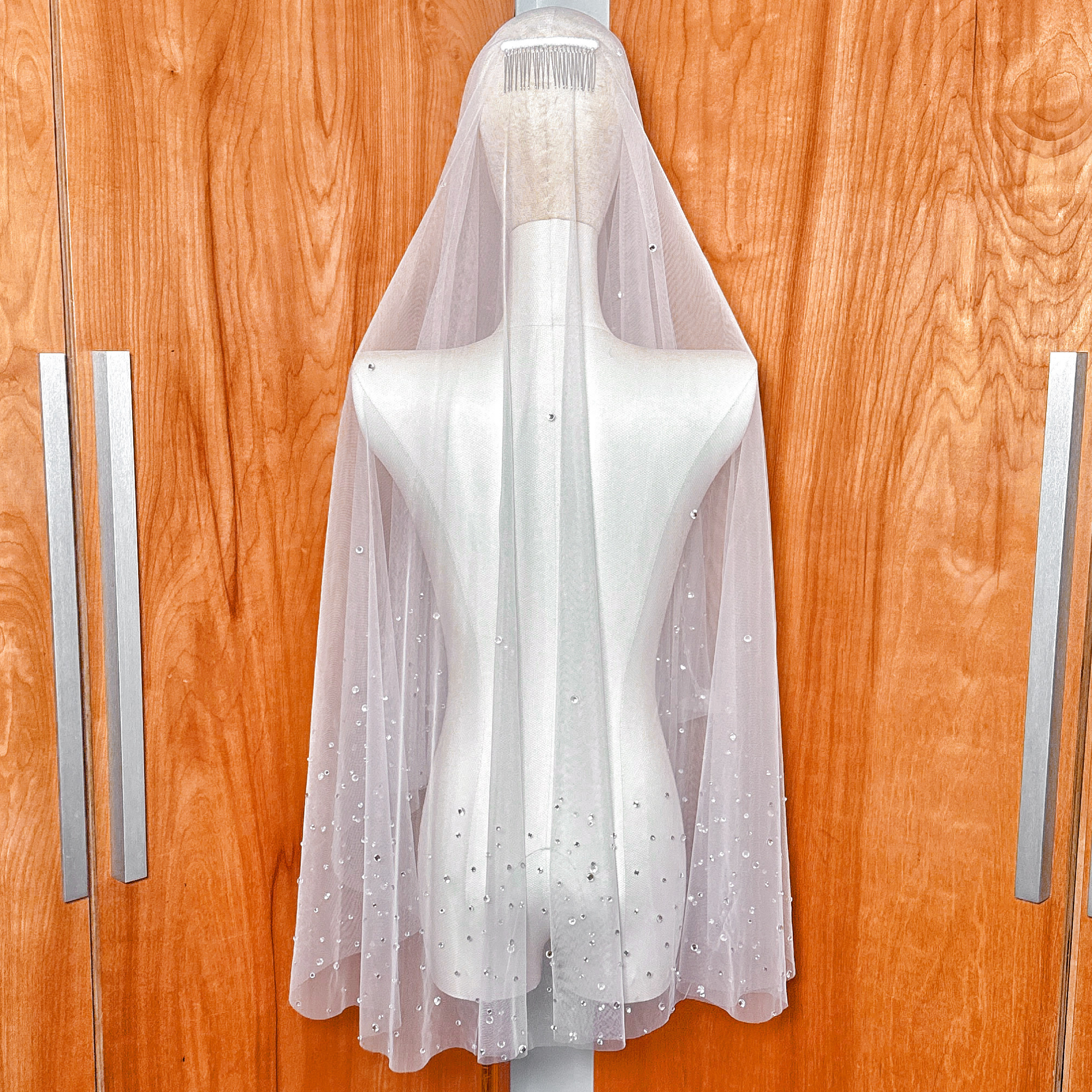 Back view of the flowing layers on the scattered rhinestone two tier wedding veil.