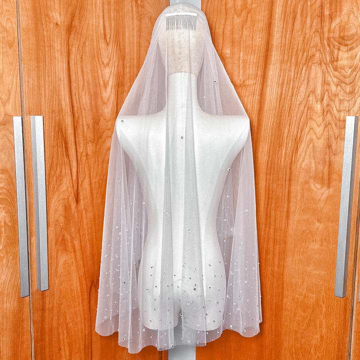 Back view of the flowing layers on the scattered rhinestone two tier wedding veil.