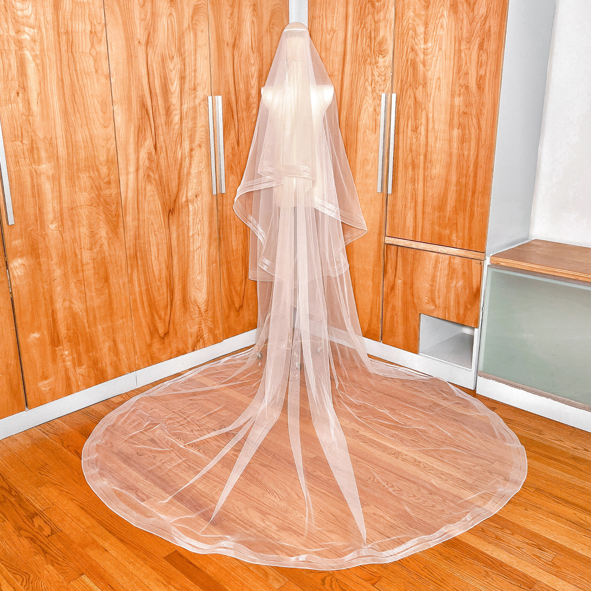 Rear view of a cathedral length two tier veil highlighting the double horsehair trim layered effect.
