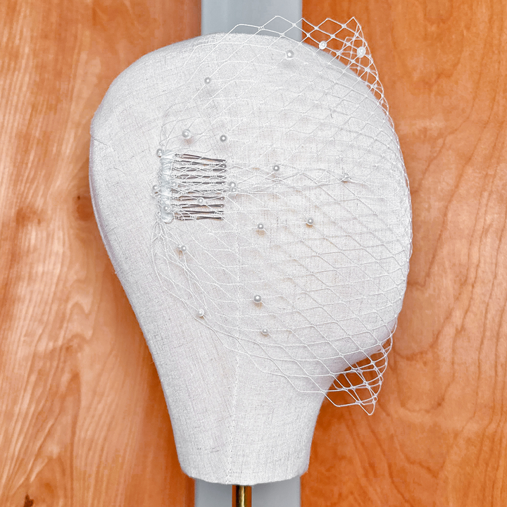 Back view of a bandeau birdcage wedding veil with pearls.