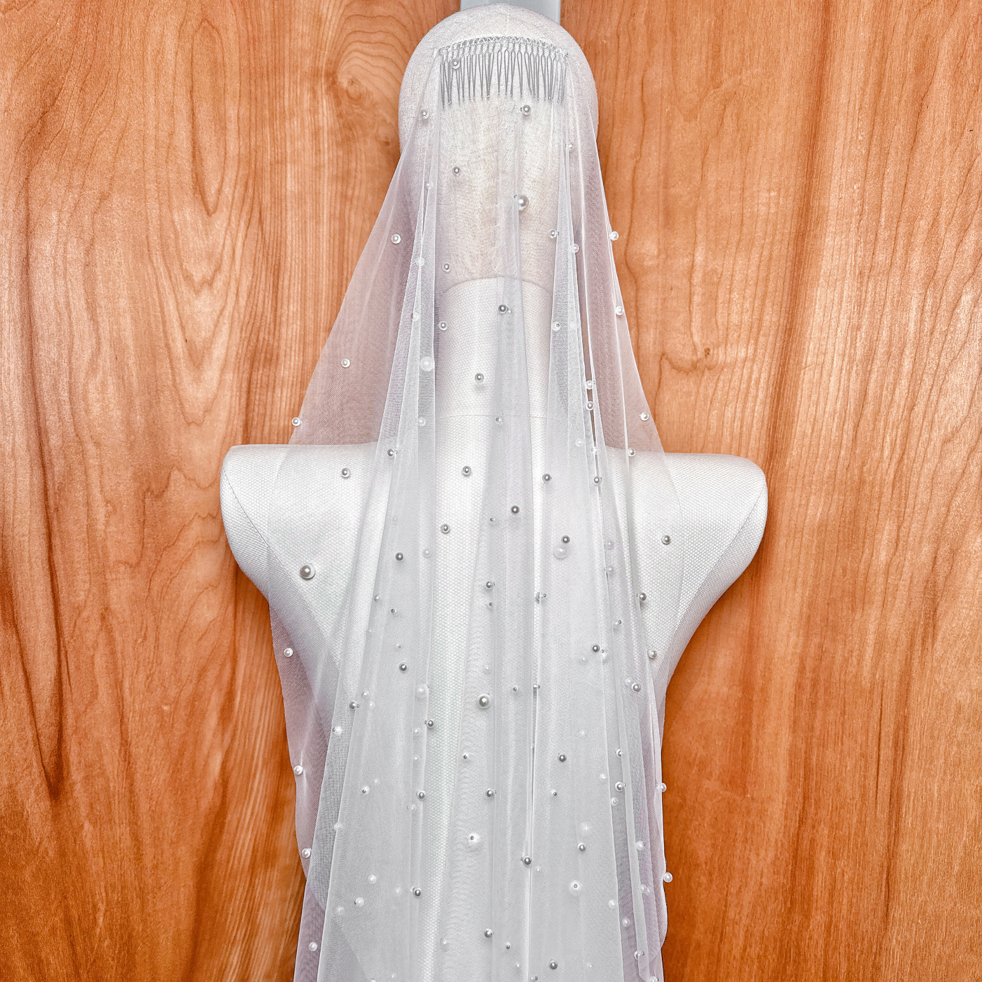 A close-up detail of the Barely There Scattered Pearl Wedding Veil highlighting the delicate pearl bead placement and sheer bridal tulle.