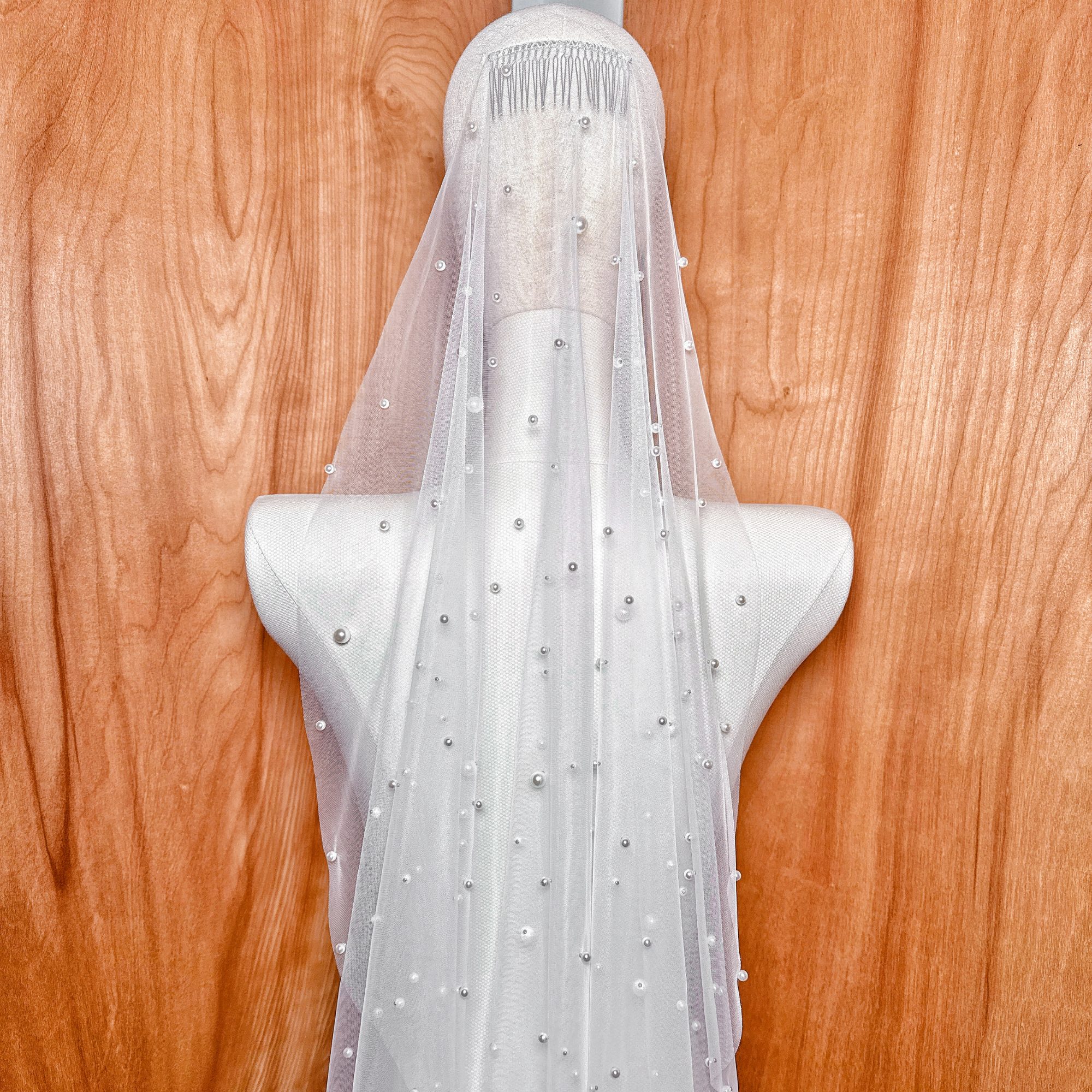 A close-up detail of the Barely There Scattered Pearl Wedding Veil highlighting the delicate pearl bead placement and sheer bridal tulle.