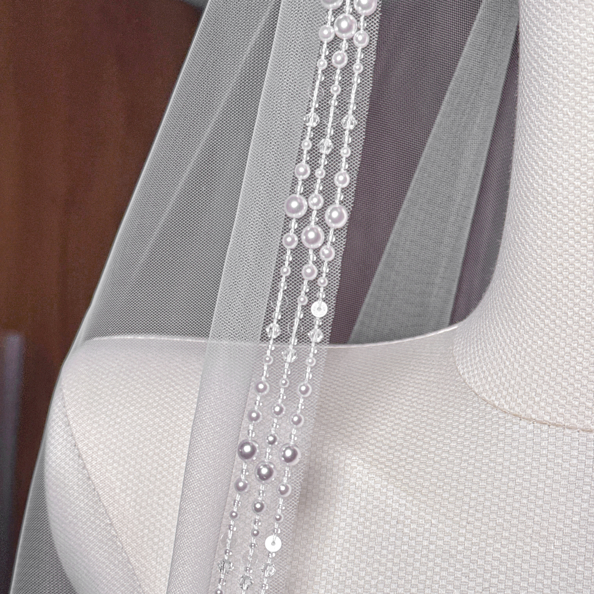 Sparkling crystals and delicate pearls on an intricately beaded cathedral length wedding veil.