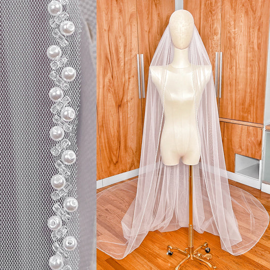 Cathedral length beaded edge wedding veil with delicate pearl trim.