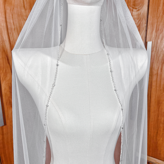 Classic ivory wedding veil with a beaded edge.