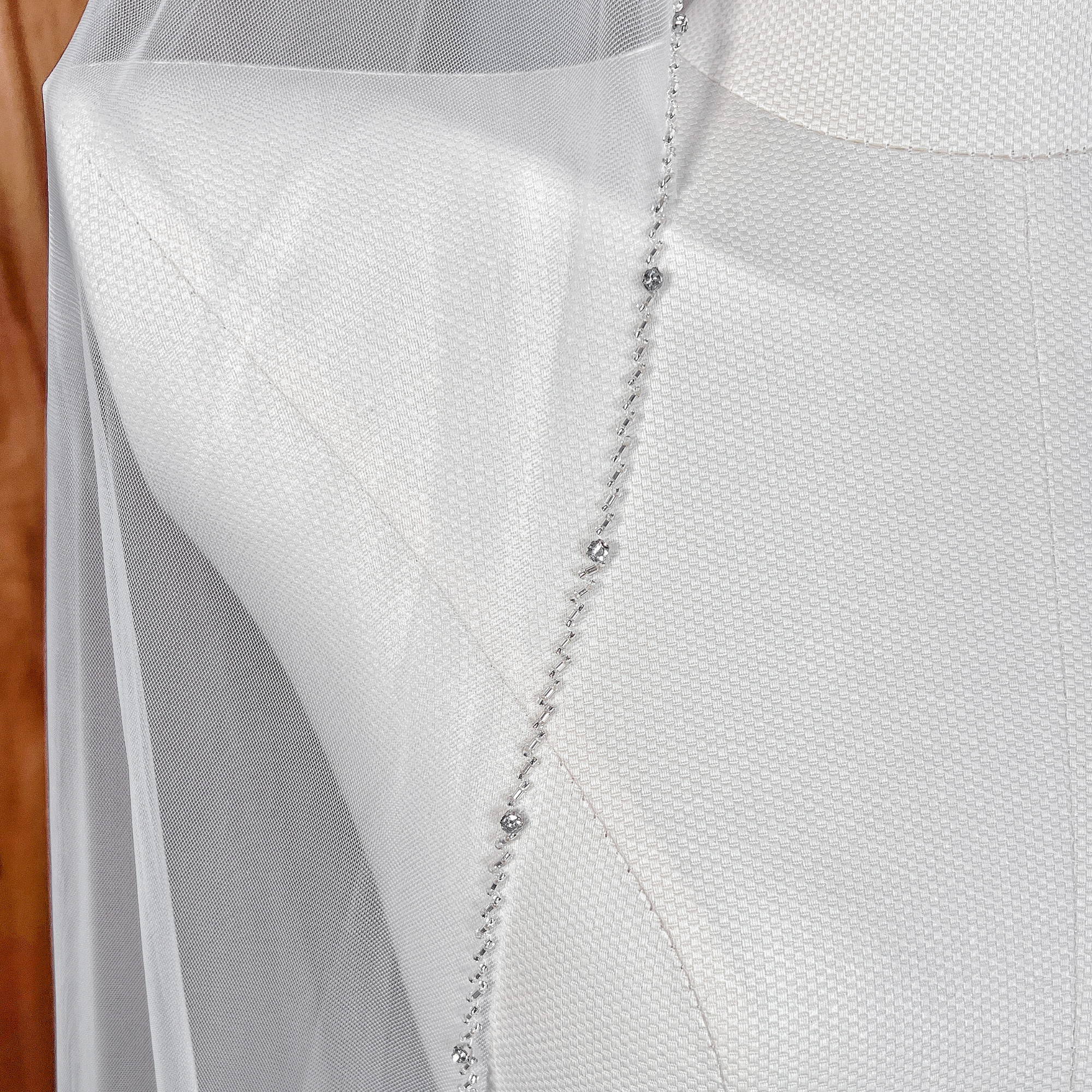 Detail view of a cascading tulle beaded edge wedding veil.