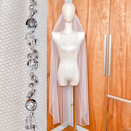Waltz length beaded edge wedding veil displayed on a bridal mannequin.