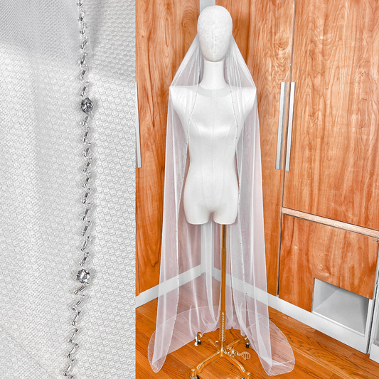 Full length view of a long beaded edge wedding veil showing the complete drape.