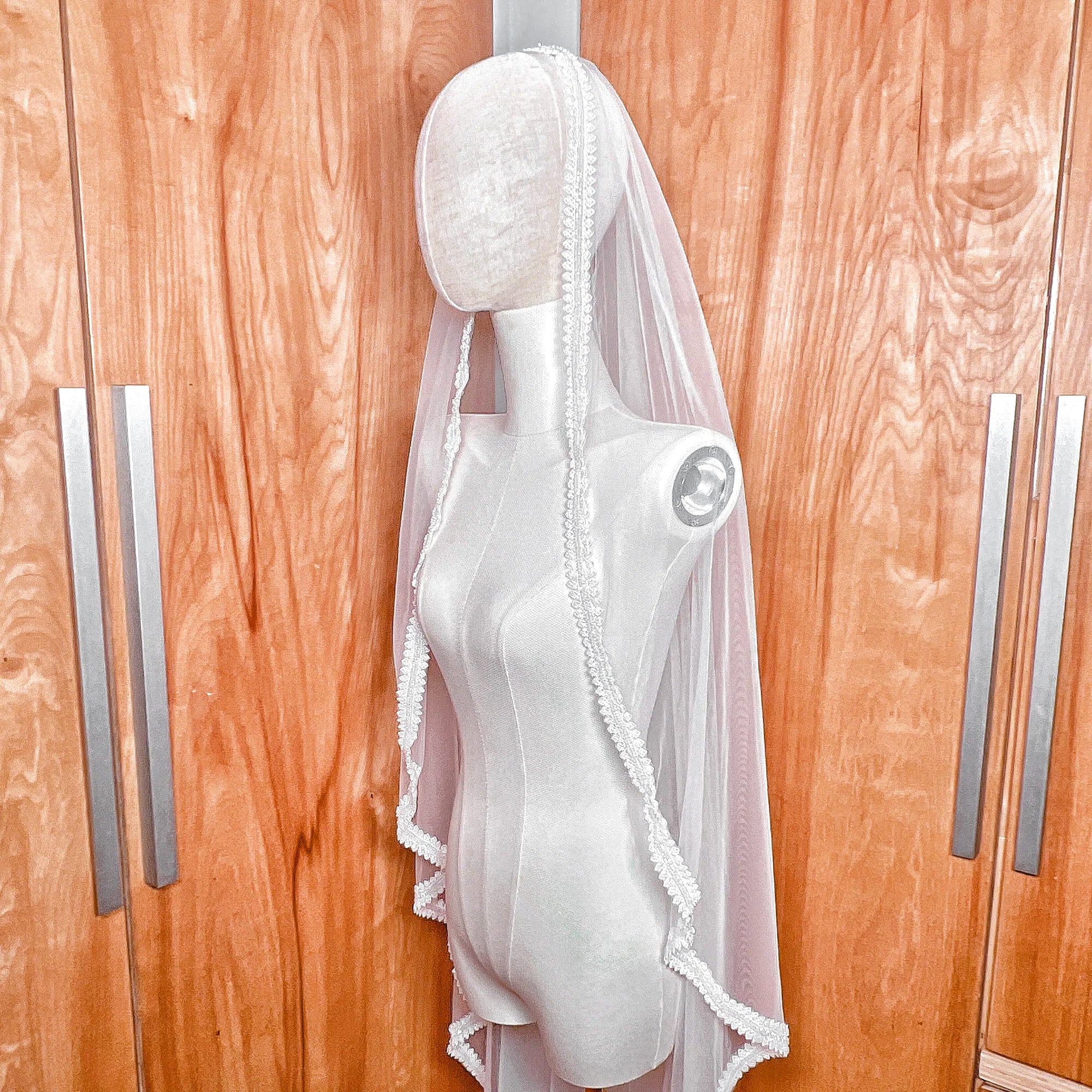 Side profile view of a beaded mantilla wedding veil.
