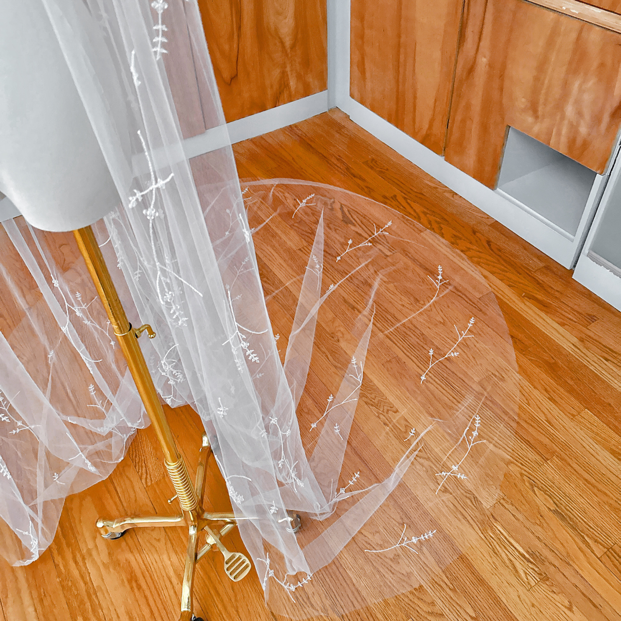 Fine tulle detail of a 3D floral embroidered veil with crystals for weddings.