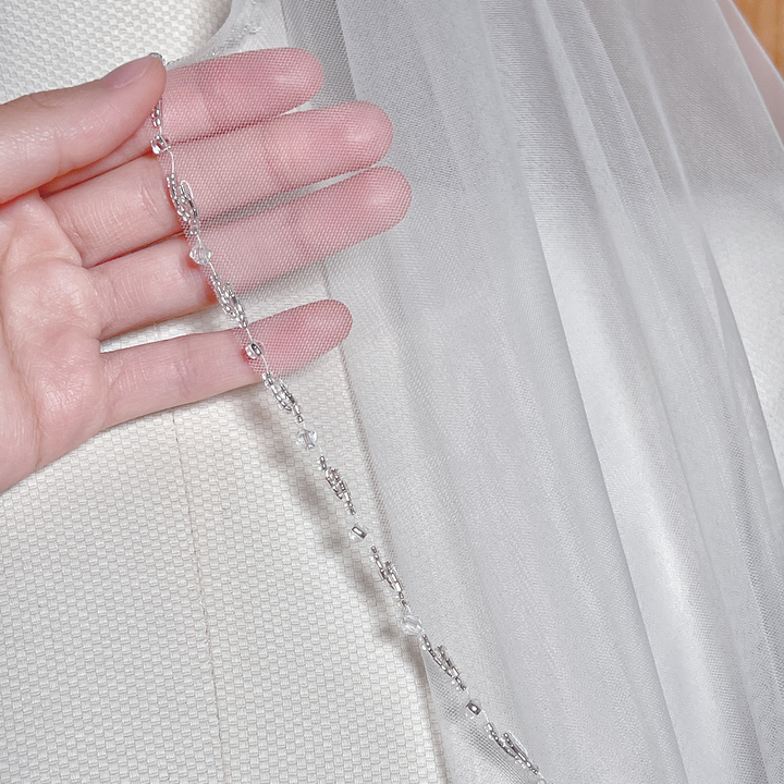 Detail view of the delicate tulle on a beaded edge wedding veil.