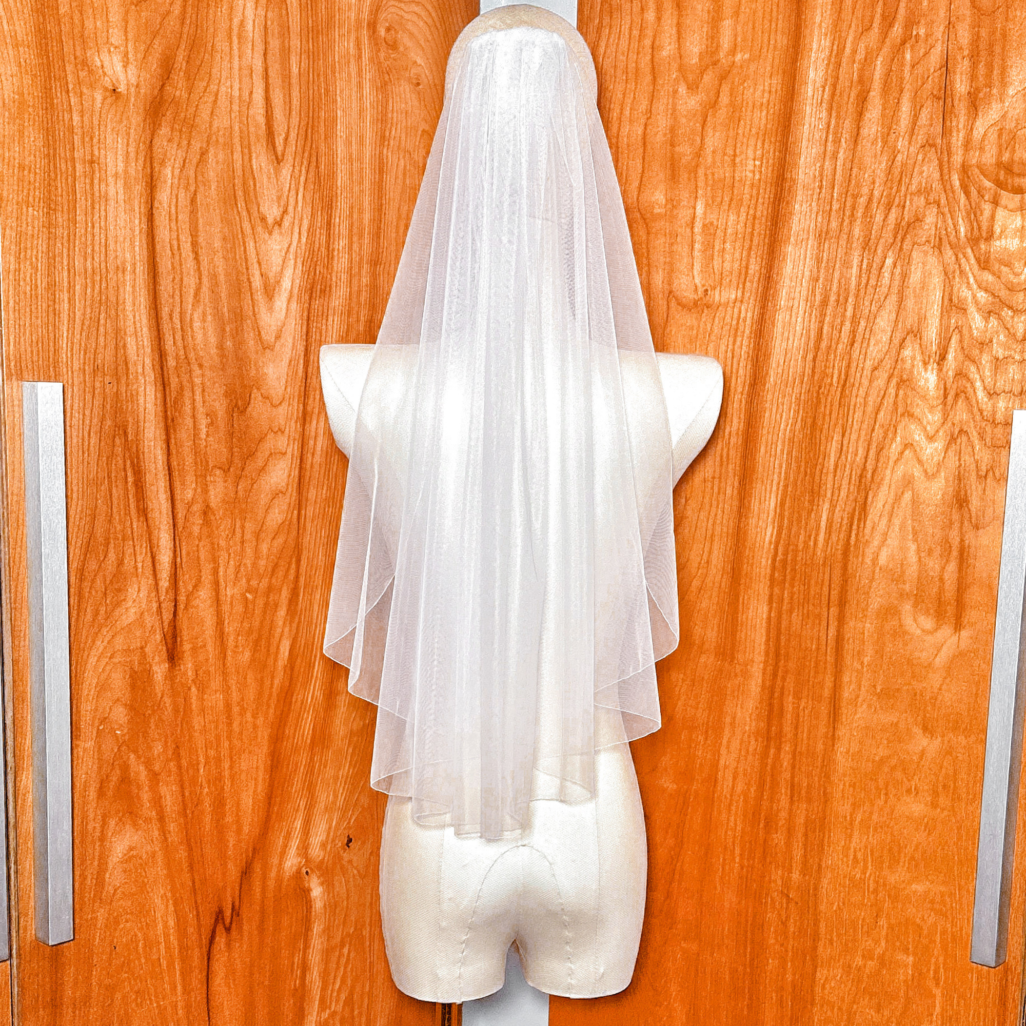 Classic bridal elbow length wedding veil featuring a delicate pencil edge.