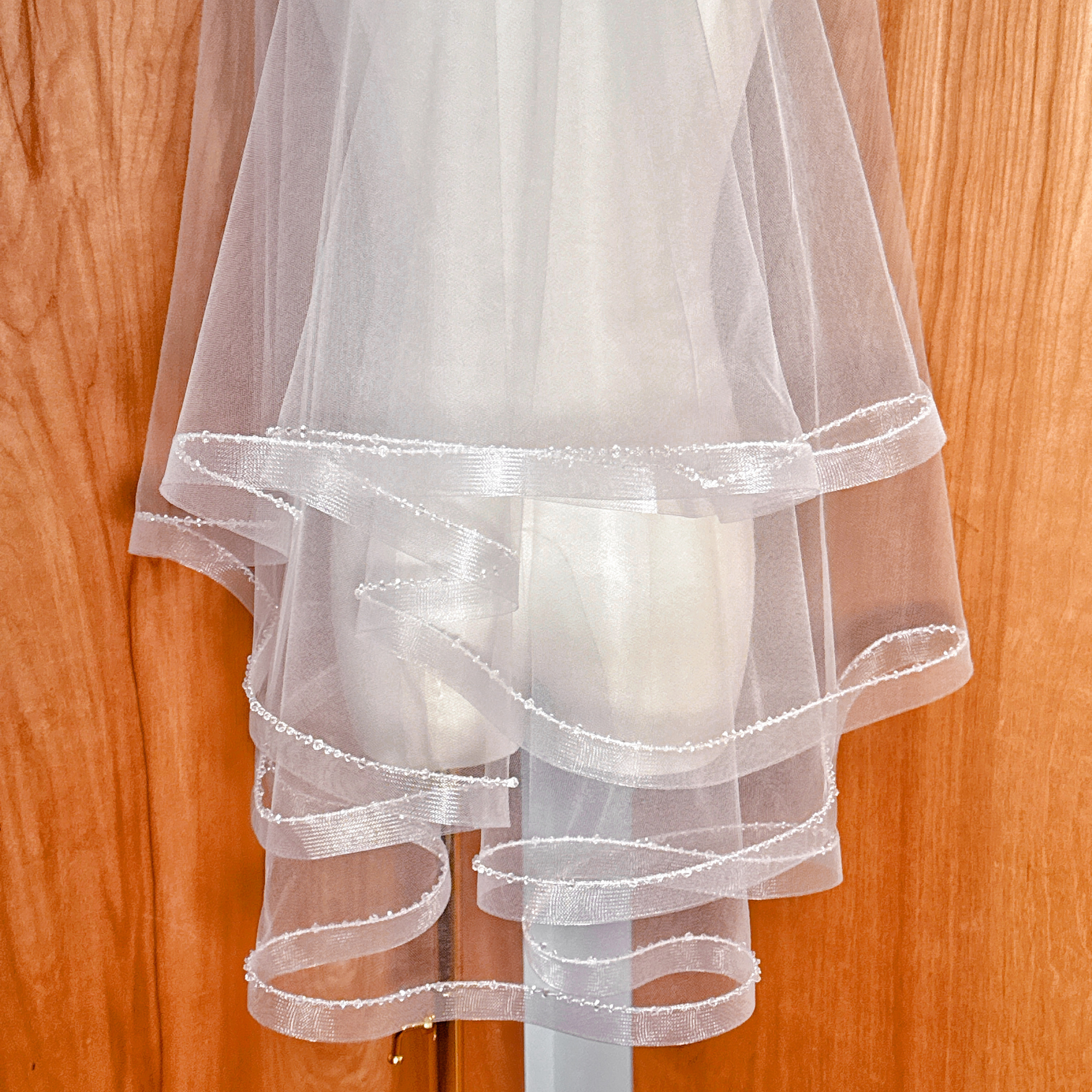 Professional mannequin display of a two tier horsehair veil with crystal trim.