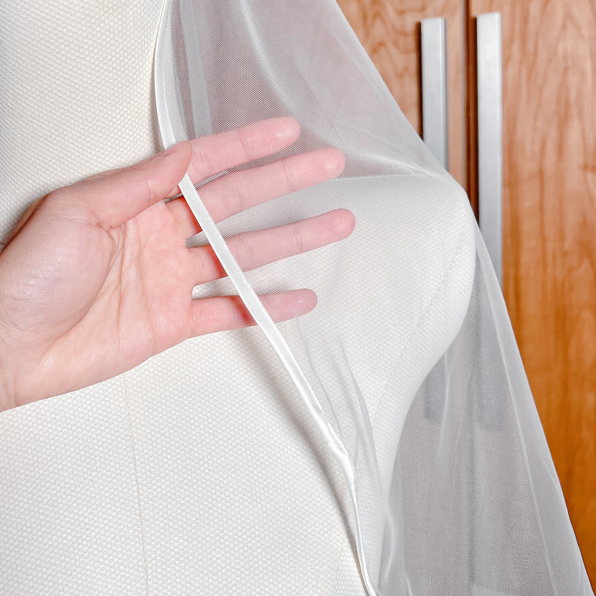 Close-up view of the delicate satin edge on a ribbon trim wedding veil.