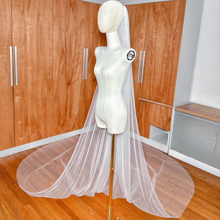 Side profile of a bridal Royal Cathedral Tulle Veil featuring a simple raw edge finish on a mannequin.