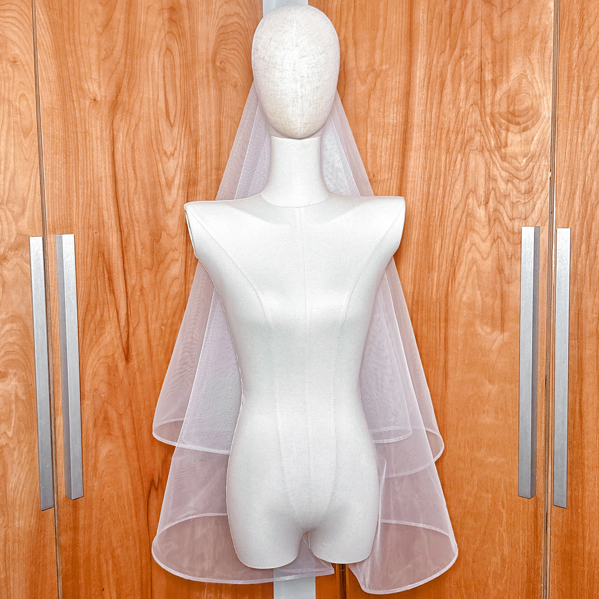Fingertip length bridal veil featuring a double layer design and 1/4 inch horsehair ribbon edge.
