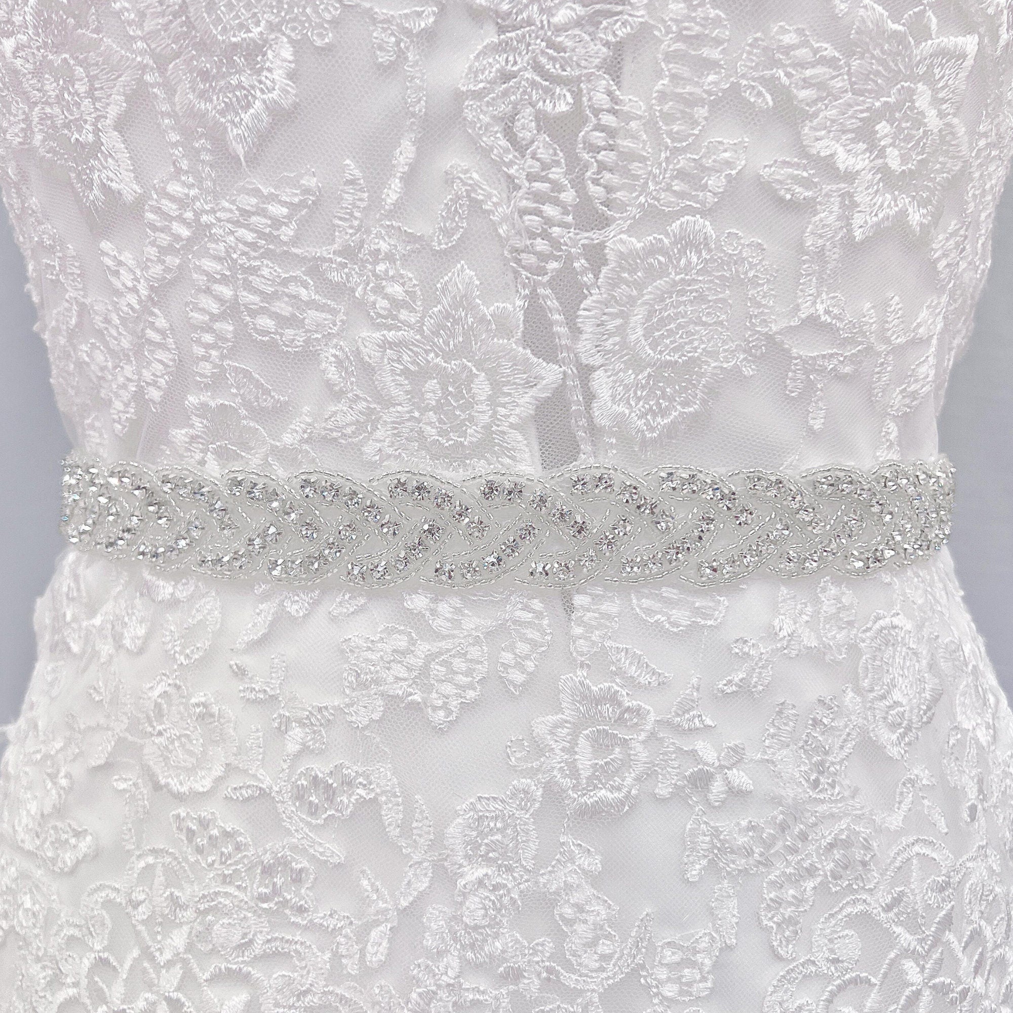 Close-up of a sparkling silver rhinestone bridal belt on a mannequin.