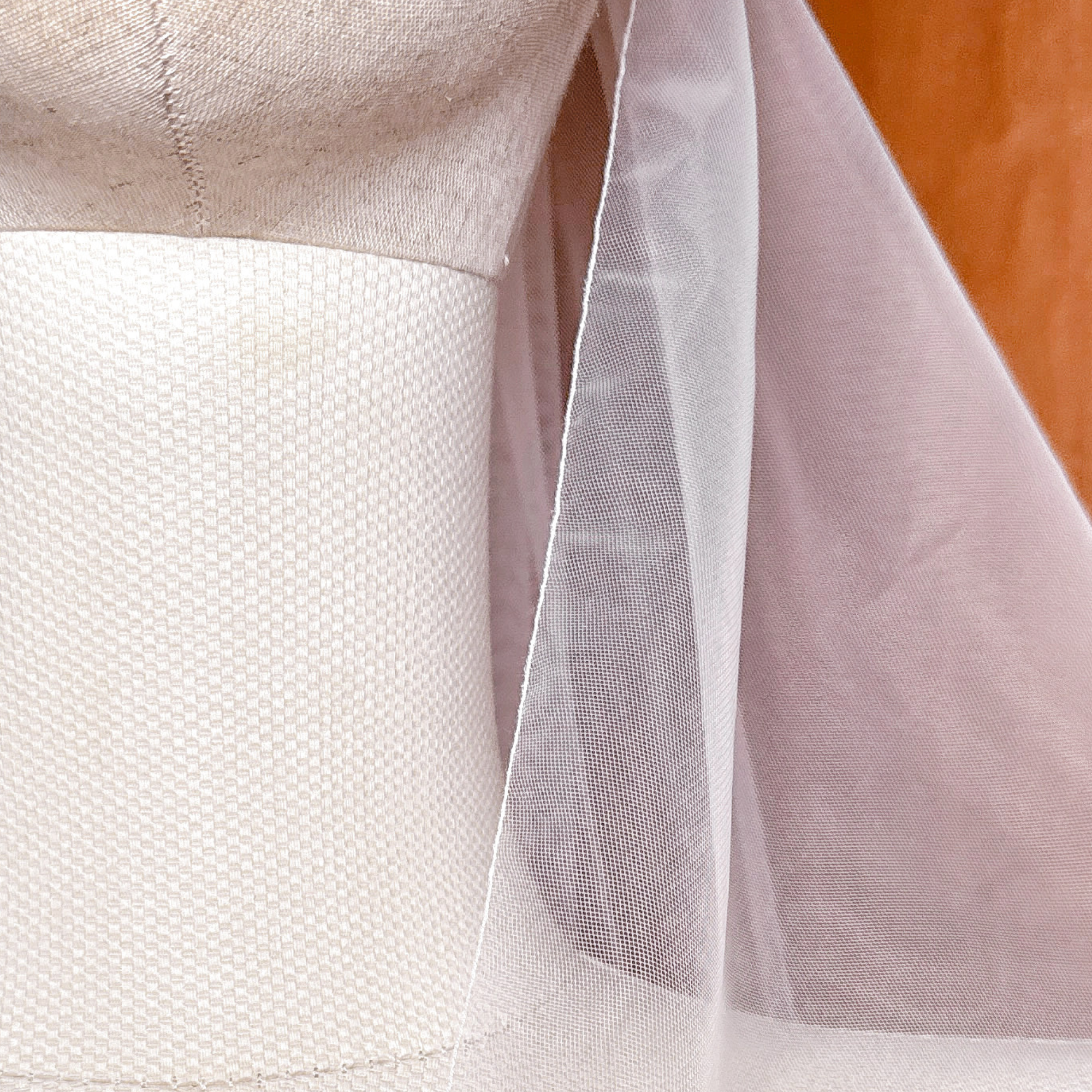 Close-up of the delicate pencil edge on a cascade knee length wedding veil.