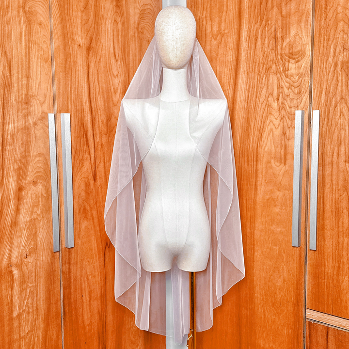 Cascade knee length wedding veil with a clean pencil edge displayed on a bridal mannequin.