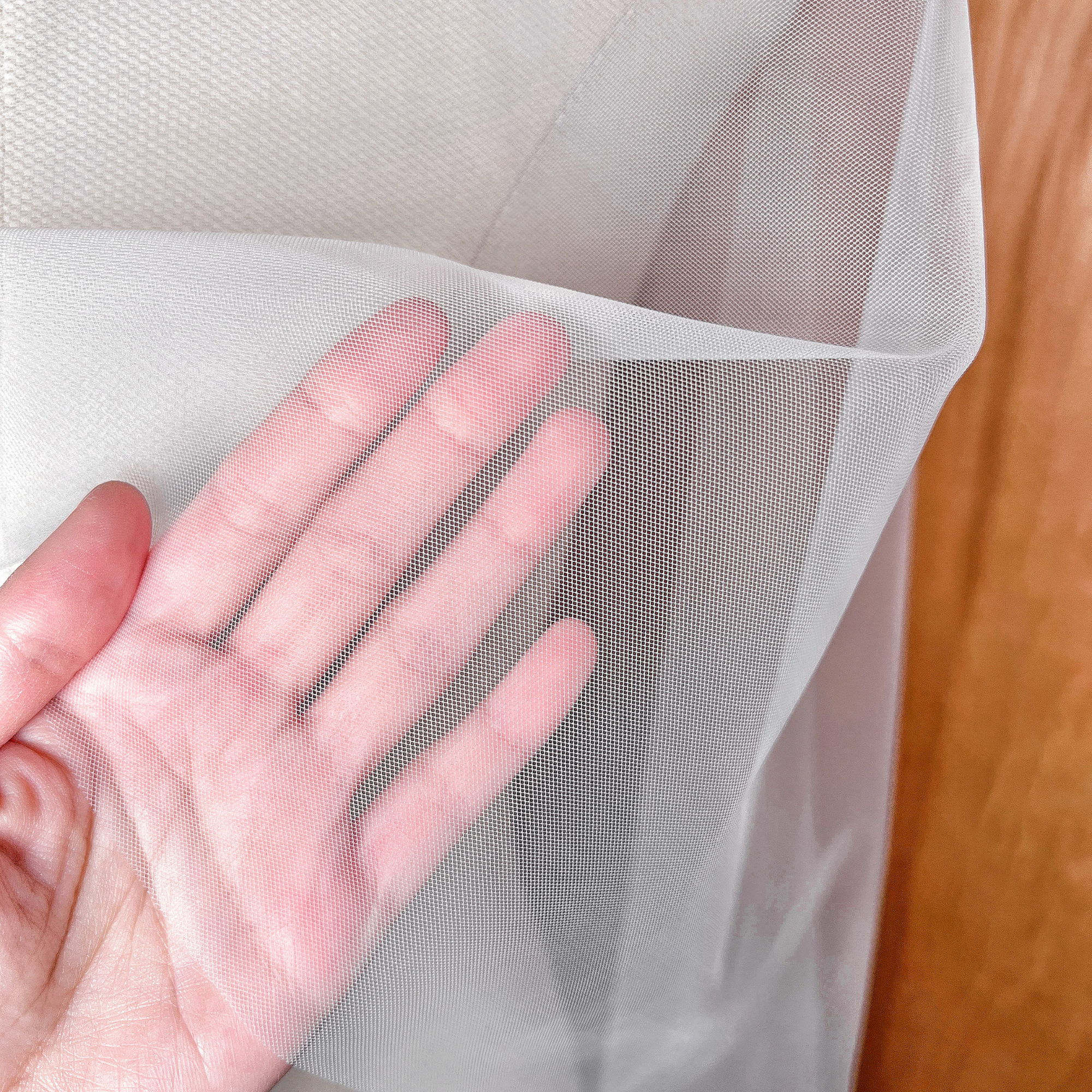 Close-up of the delicate raw edge and soft tulle fabric of the cascade waltz length wedding veil.