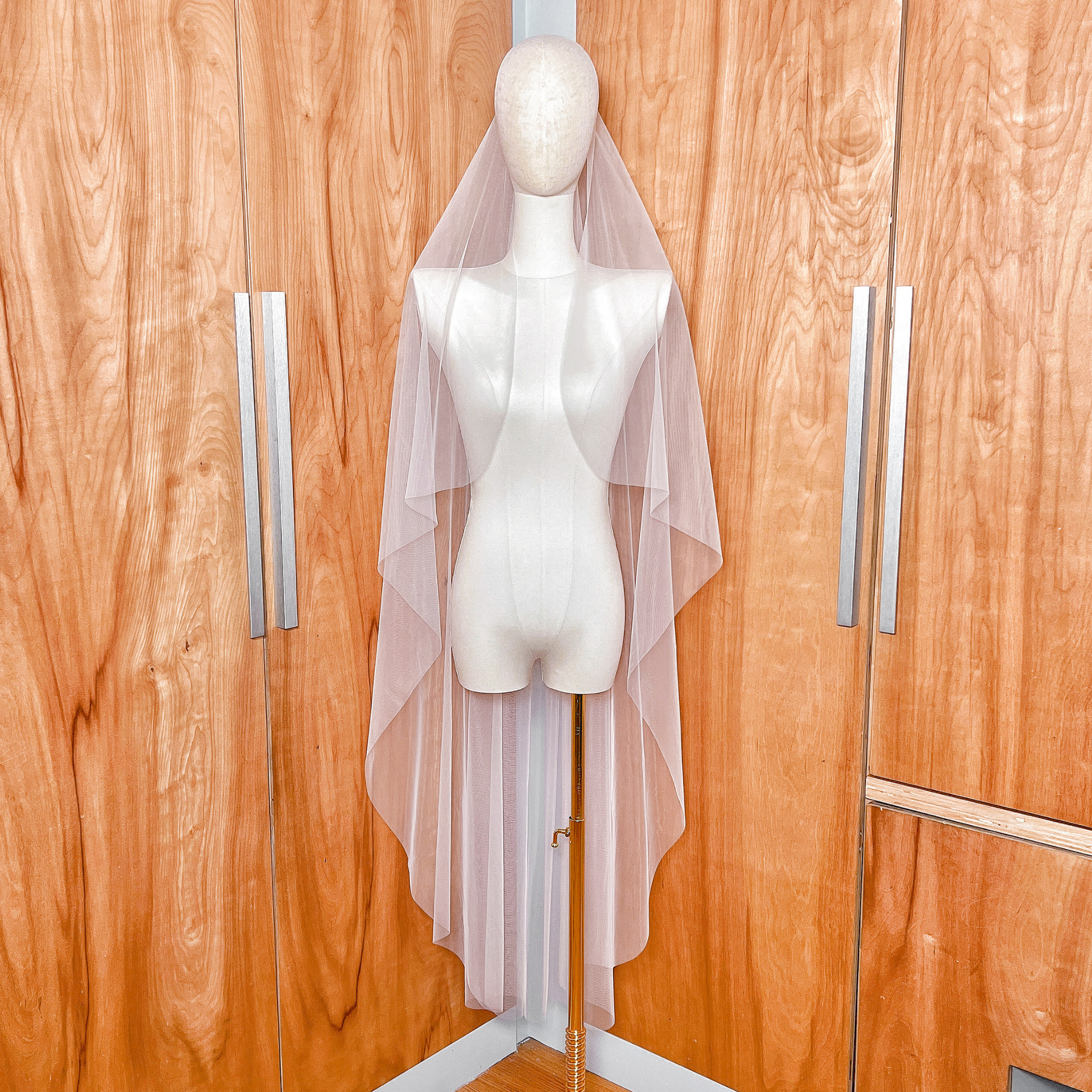 Front view of the cascade waltz length wedding veil with a clean raw edge finish.